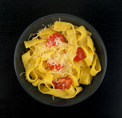 Yellow italian pasta pappardelle, fettuccine or tagliatelle
