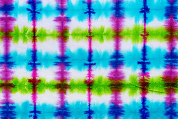 striped tie dye pattern hand dyed on cotton fabric abstract background.