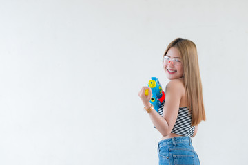 Asian sexy woman with gun water in hand on white background,Festival songkran day at thailand,The best of festival of thai,Land of  smile