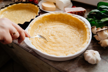 The process of making French quiche. Ingredients pie quiche. French quiche with cheese, spinach, mushrooms, bacon, dried tomatoes. Cooking.