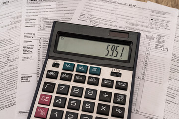 Calculator on 1040 tax form close up