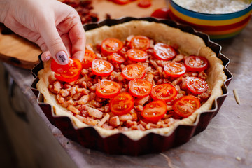 The process of making French quiche. Ingredients pie quiche. French quiche with cheese, spinach, mushrooms, bacon, dried tomatoes. Cooking.