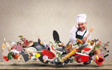 Cheerful chef drumming on pots and pans