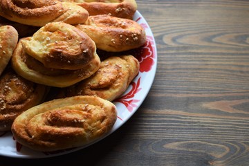 Fresh salt cake with cheese and garlic on a wooden table