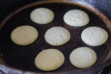 Making pancakes on frying pan top view