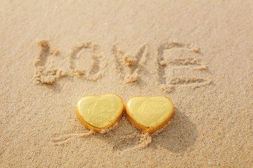 Chocolate color Lovely golden heart on the beach. Background is a natural in real place, creative Valentine's Day Concept, tropical style background made in Phuket, Thailand.
