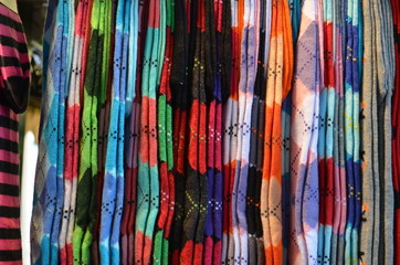 Colourful socks in vertical display at a store stand
