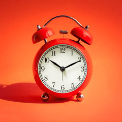 Close up red alarm clock on red background