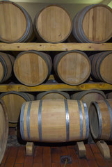 Wine barrels stacked in a old cellar at winery