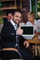 Male Office Worker Showing Thumb Up in Office