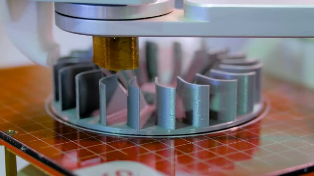 3D Printer machine printing plastic workpiece look like metal at futuristic technology exhibition. 3D printing, additive technologies, 4.0 industrial revolution and manufacturing concept