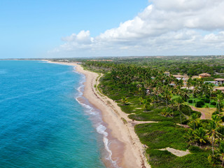Aerial view of tropical white sand beach and turquoise clear sea water with small waves and palm...