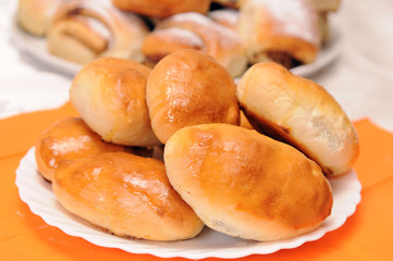 a stack of buns on a white plate