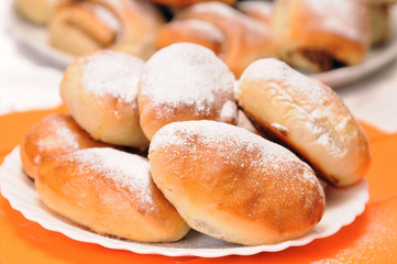 a stack of buns on a white plate