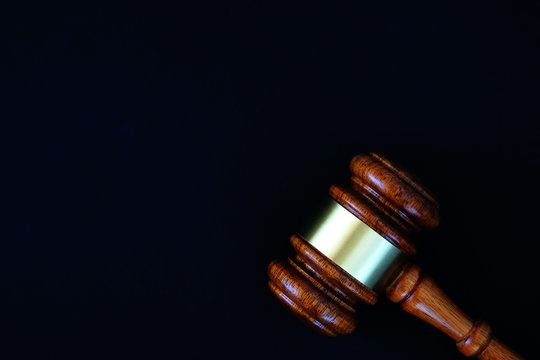 Judges wooden gavel on black background, justice concept.