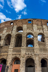 Fototapeta premium Facade of the Great Roman Colosseum (Coliseum, Colosseo), also known as the Flavian Amphitheatre. Famous world landmark. Scenic urban landscape.