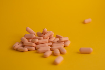 pills in yellow background