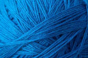 Blue yarn clew close up texture. Blue wool background