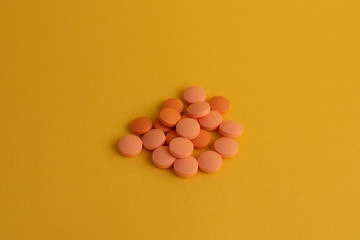 pills in yellow background