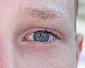 Fototapeta premium One eye of a teenager macro close-up