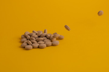 pills in yellow background