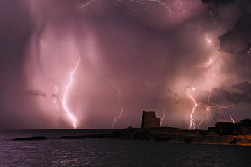 A storm of lightning strikes over ancient ruins