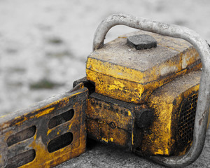 Rusted dirty yellow chain saw