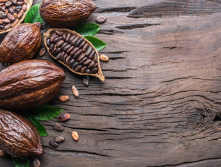 Cocoa pod and cocoa beans on the wooden table. Top view.