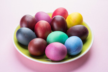 Colorful Easter eggs as an attribute of Easter celebration. Pink background.