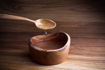 Fasting, Lent. Spoon and cup of water on wooden background