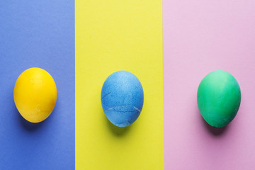 Stained Easter eggs as an attribute of Easter celebration on colorful background.