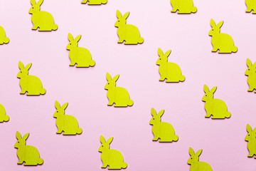 Wooden Easter Bunnies as attribute of Easter celebration. Pink background.
