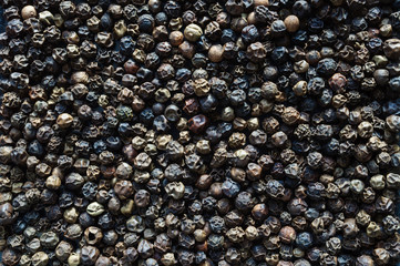 Peas black fragrant pepper top view, background.