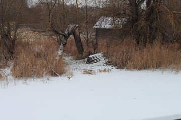 house on the shore of the lake. inverted boat