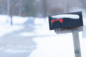 Winter mail boxes in the snow with shallow depth of field