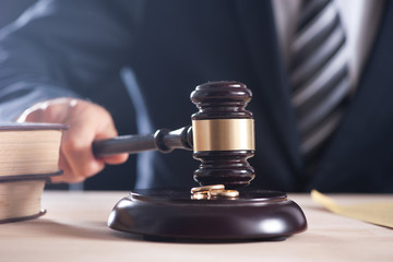 Hand of a judge holding a hammer or gavel