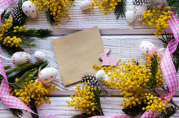 Easter egg and beautiful Mimosa flower on a wooden background. - Image