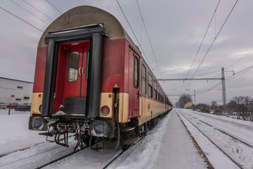 Lipany station in winter snow morning with trains and platforms