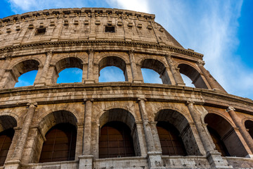 Golden sunset at the Great Roman Colosseum (Coliseum, Colosseo), also known as the Flavian Amphitheatre. Famous world landmark. Scenic urban landscape.