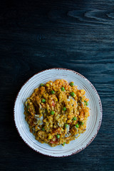Lentil porridge with vegetables and herbs. Healthy lifestyle. Dietary menu. Dark wooden background. View from above.