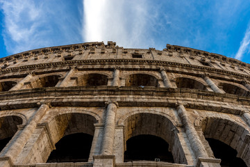 Golden sunset at the Great Roman Colosseum (Coliseum, Colosseo), also known as the Flavian Amphitheatre. Famous world landmark. Scenic urban landscape.