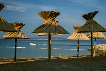 Nice view of beach Croatia. Crystal clear waters and beach umbrellas . Croatia vacation. Europe. European travel.
