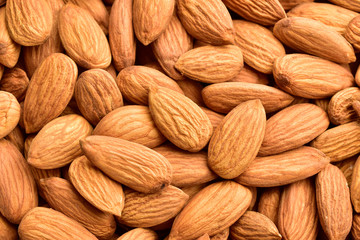 Macro image of badam, almonds textured background.