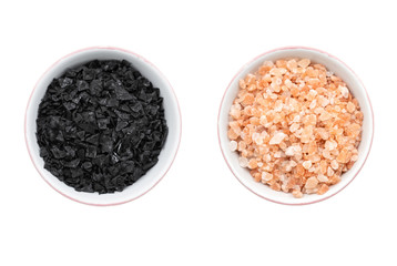 A bowl of himlayan pink salt next to a bowl of mediterranean sea salt