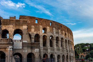 Fototapeta premium Golden sunset at the Great Roman Colosseum (Coliseum, Colosseo), also known as the Flavian Amphitheatre. Famous world landmark. Scenic urban landscape.