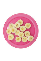 Sliced banana on a pink plastic plate