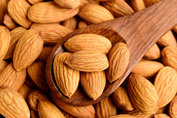 almonds in wooden spoon, top view, badam.