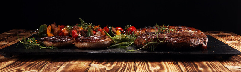 Assorted delicious grilled meat with vegetable on a barbecue with steak