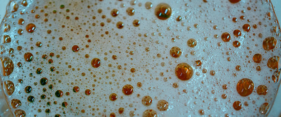 foam with bubbles on the surface of the beer fragment macro