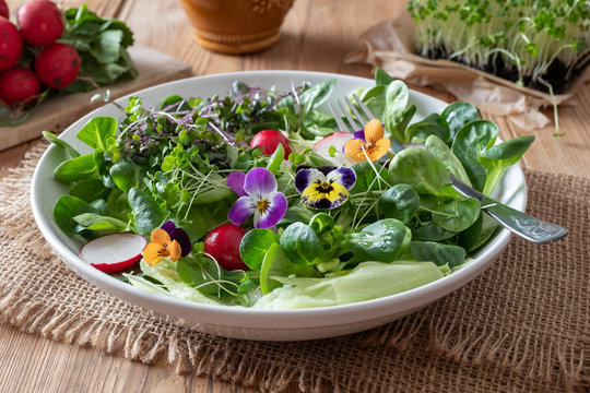 Salad With Edible Pansies And Fresh Broccoli And Kale Microgreens